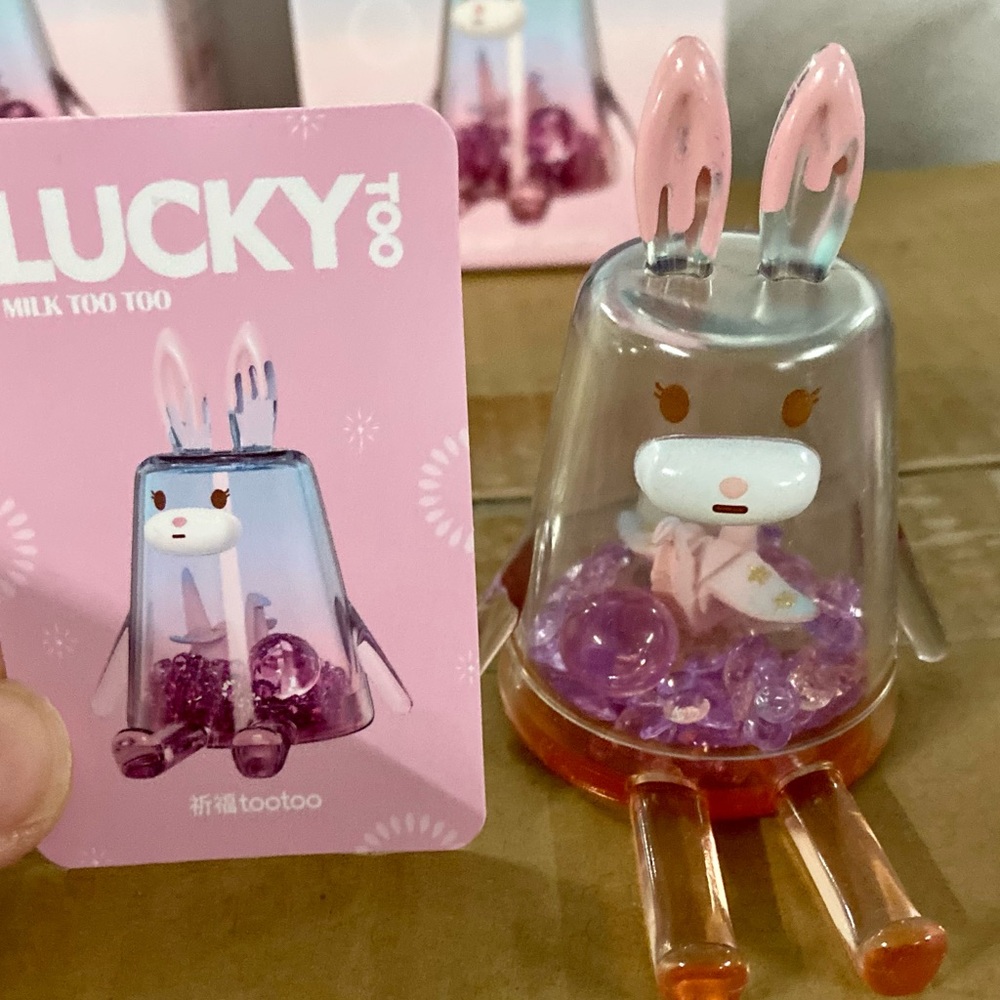 Designer toy “Lucky” phone stand series.  Purple with beads and an oragami bird.